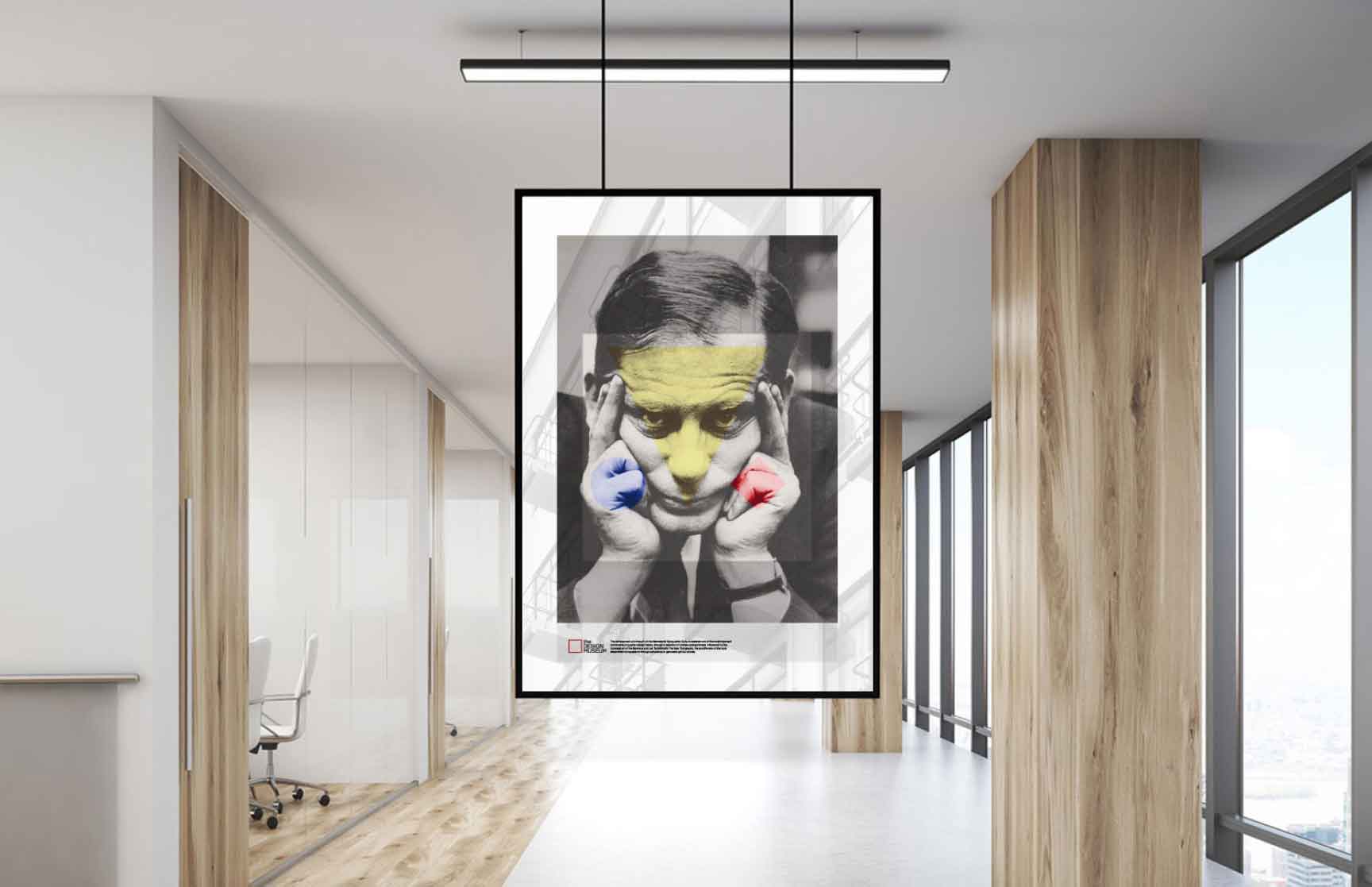 A minimalist Swiss-style poster displayed in a modern office setting. The design features a grayscale portrait of a man holding his head with both hands, accented by bold geometric elements. A transparent yellow triangle overlays the upper face, with solid red and blue circles highlighting the hands. The composition includes clean, structured typography in the lower section, emphasizing the Design Museum and details about the Swiss exhibition. The setting includes sleek wood paneling, glass walls, and natural lighting, enhancing the contemporary atmosphere.