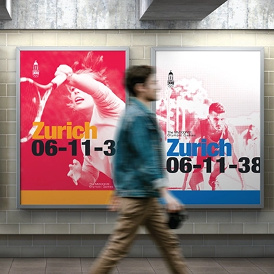 Poster design for the Zurich 2038 Winter Olympic Games displayed in a subway setting. The vibrant Swiss-style poster features a dynamic image of an athlete in motion, with bold blue and red text reading ‘Zurich 06-11-38,’ along with the Zurich Olympic logo at the top. The composition is clean and modern, emphasizing movement and energy.