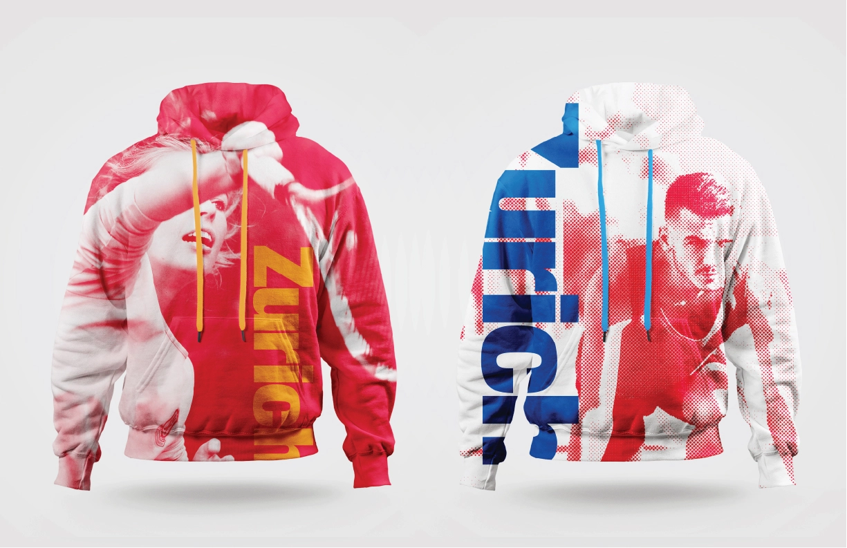 Two hoodies inspired by the Zurich 2038 Winter Olympic Games, showcasing bold Swiss-style designs. The left hoodie features a vibrant red halftone image of a tennis player mid-swing with yellow vertical typography reading ‘Zurich.’ The right hoodie displays a red halftone image of a sprinter in motion, complemented by bold blue typography running vertically along the side. Both hoodies incorporate a modern aesthetic with clean, dynamic lines and colorful drawstrings that match the design elements, reflecting energy and Swiss design precision.