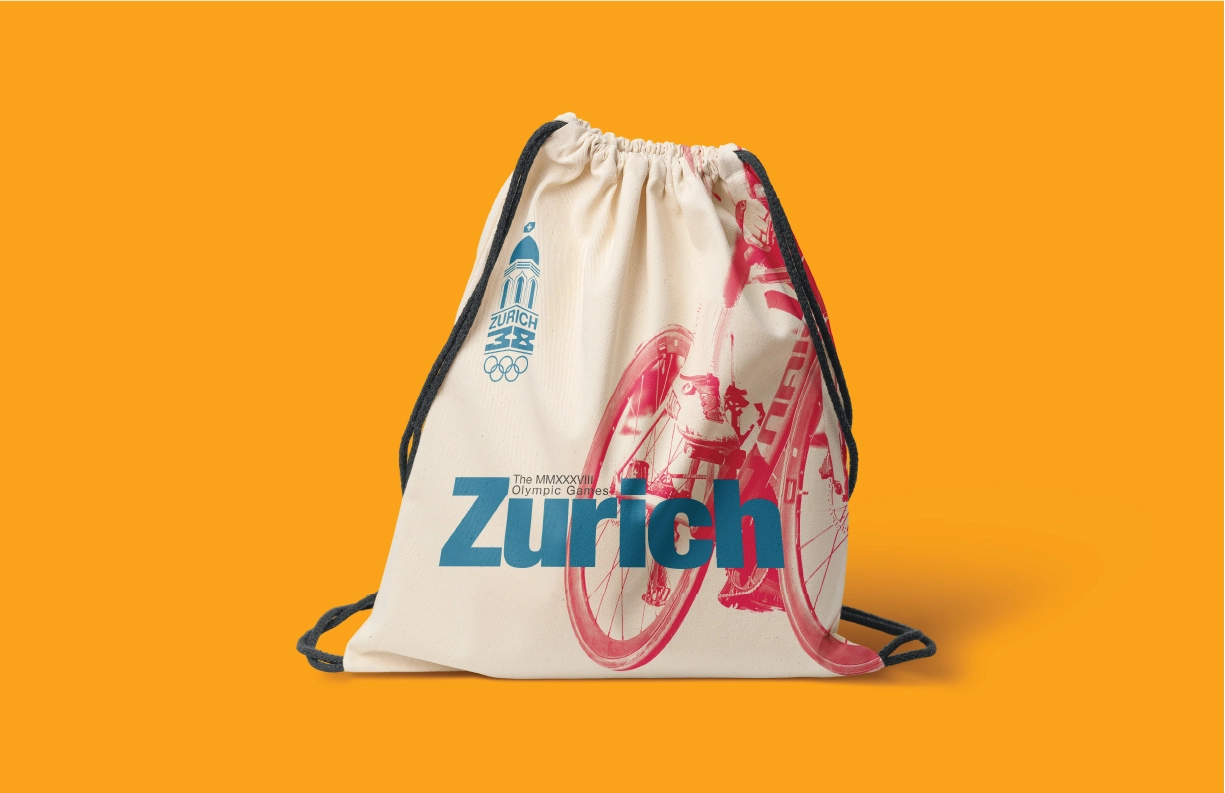 A drawstring bag designed for the Zurich 2038 Winter Olympic Games, featuring a bold Swiss-inspired aesthetic. The design showcases a red halftone image of a cyclist in motion, paired with blue typography reading ‘Zurich’ and the event logo at the top left. The logo includes a stylized dome, Swiss cross, and Olympic rings. The beige fabric and dynamic composition are set against a vibrant orange background, emphasizing energy and modernity.